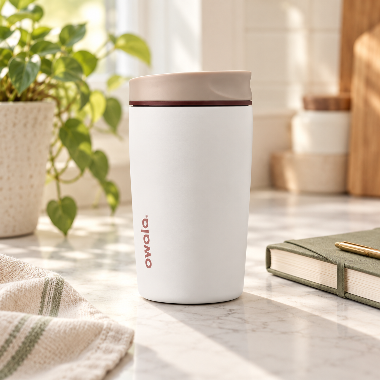 White Owala SmoothSip coffee tumbler on a kitchen counter