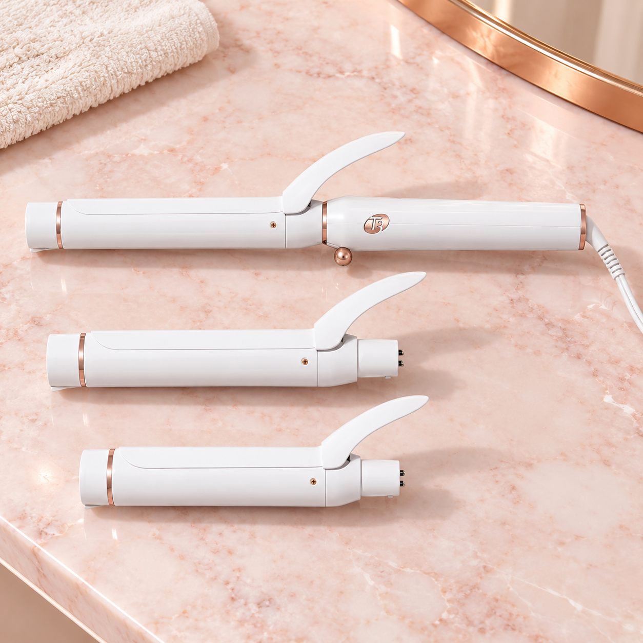 White and rose gold T3 Switch Kit curling iron with three interchangeable barrels