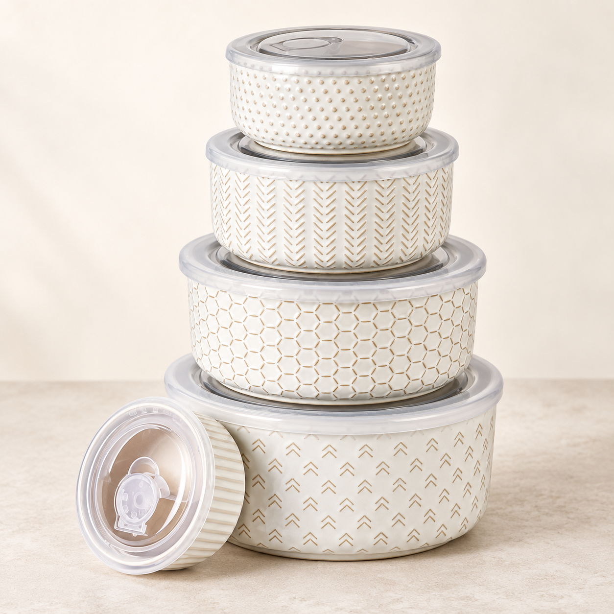 Five cream ceramic food storage bowls with clear lids and neutral geometric patterns