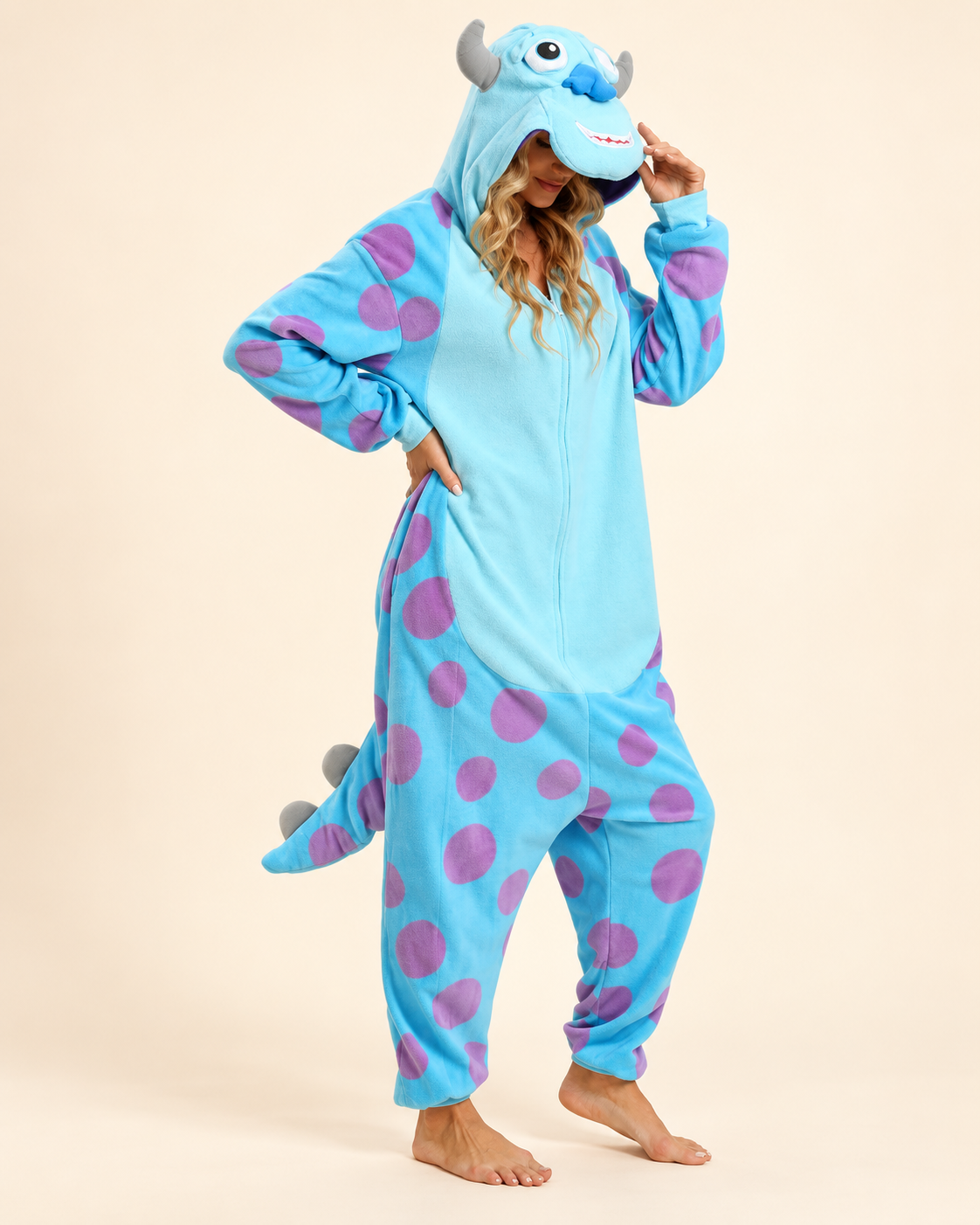 Adult wearing a blue monster fleece costume onesie
