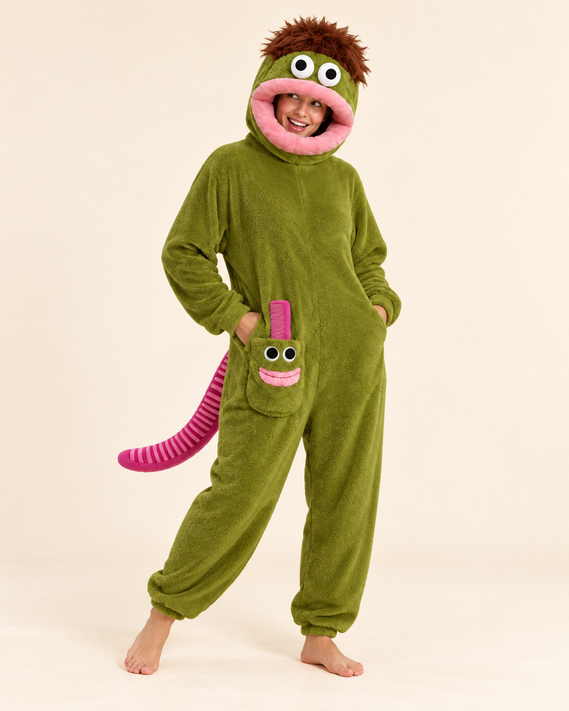 Adult wearing an olive-green big-mouth monster costume onesie