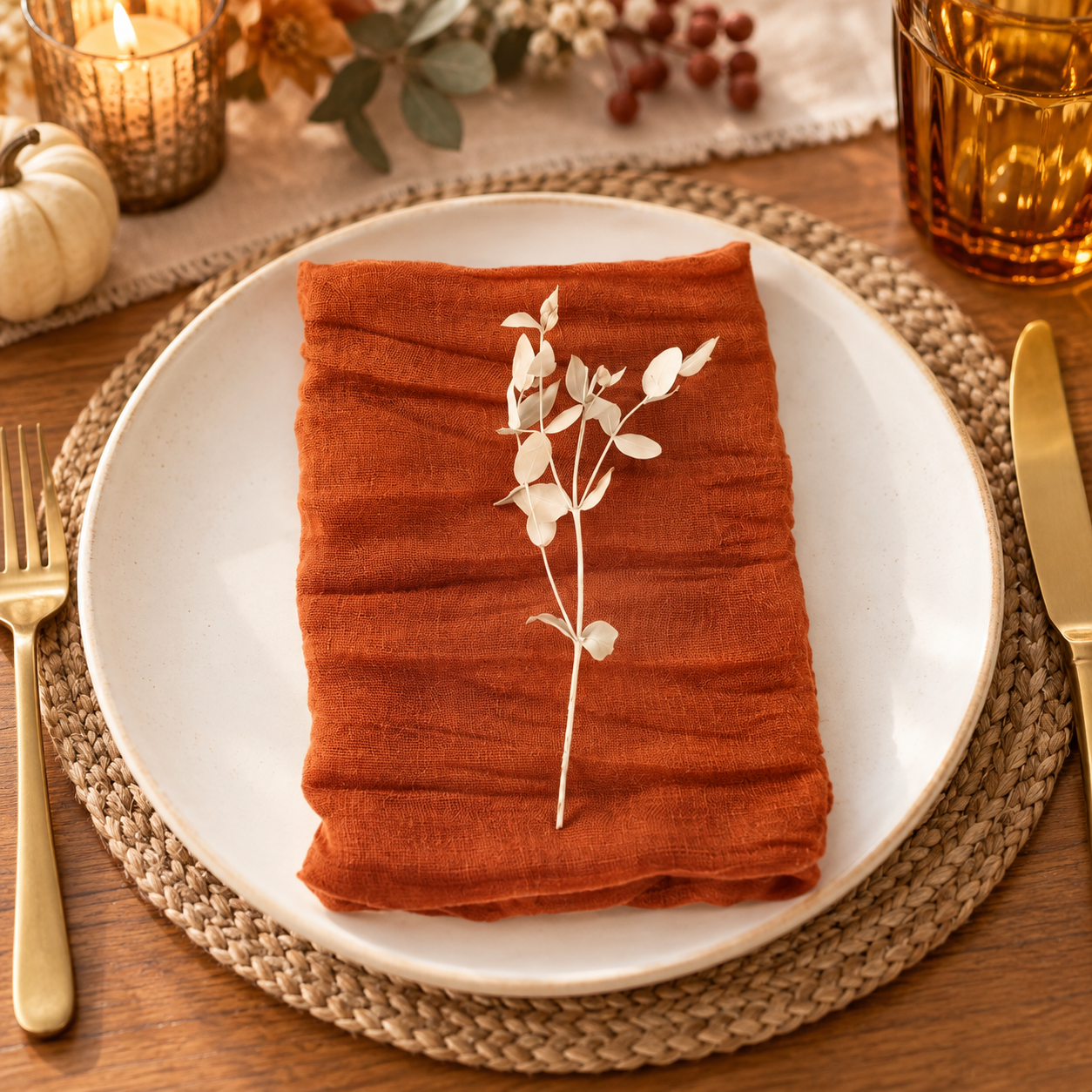 Terracotta gauze cloth napkin styled on a cozy Friendsgiving place setting